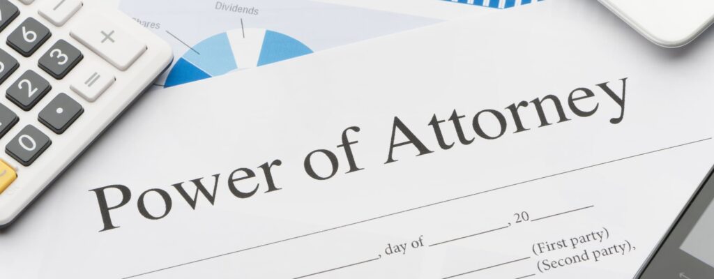 Blank power of attorney form with paperwork, phone and digital tablet.